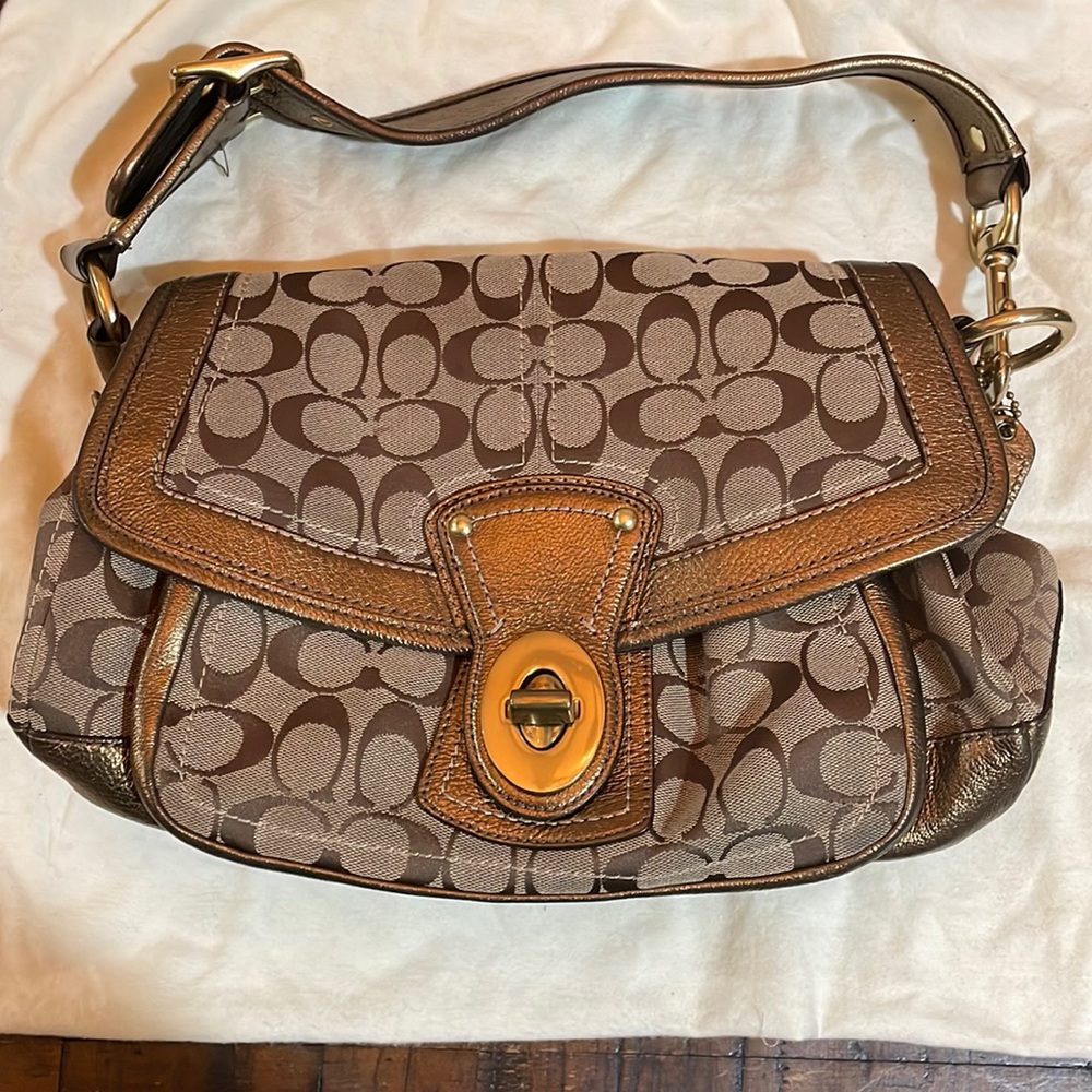 Coach legacy brown and gold monogram shoulder bag. Multicolored striped inside
